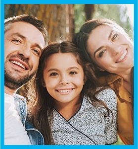 young family showing off their smiles